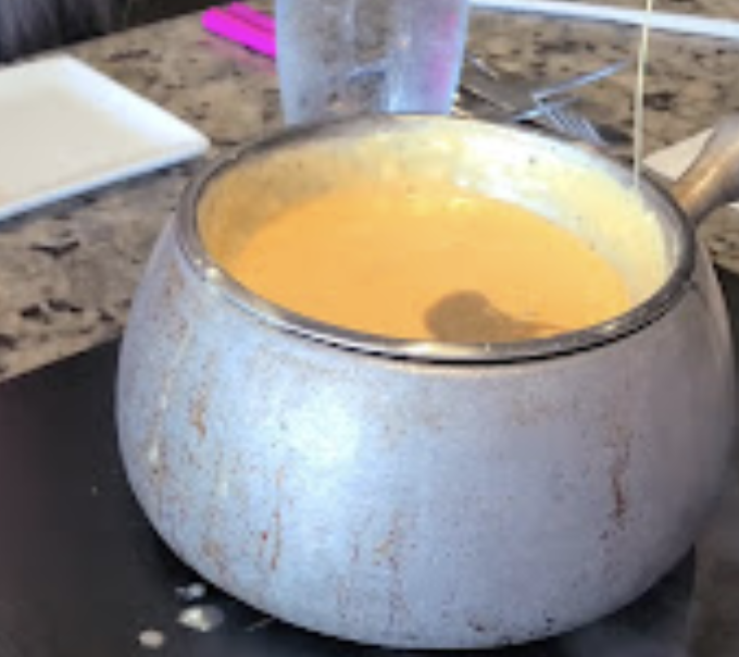 The Melting Pot signature dishes Classic Alpine Cheese Fondue
Wisconsin Cheddar
Coq Au Vin